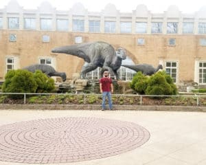 Brett in Front of the Fernbank Science Museum in Atlanta, Georgia. Has a dinosaur in the background